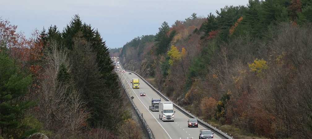 Site of proposed Hwy 401 E wildlife overpass, heavy vehicular traffic shown on highway between Canadian Shield and forest landscape